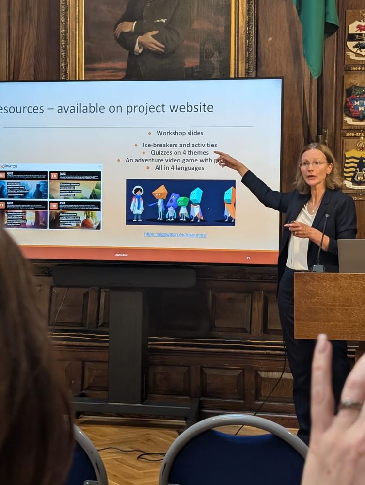 A woman pointing at a large screen