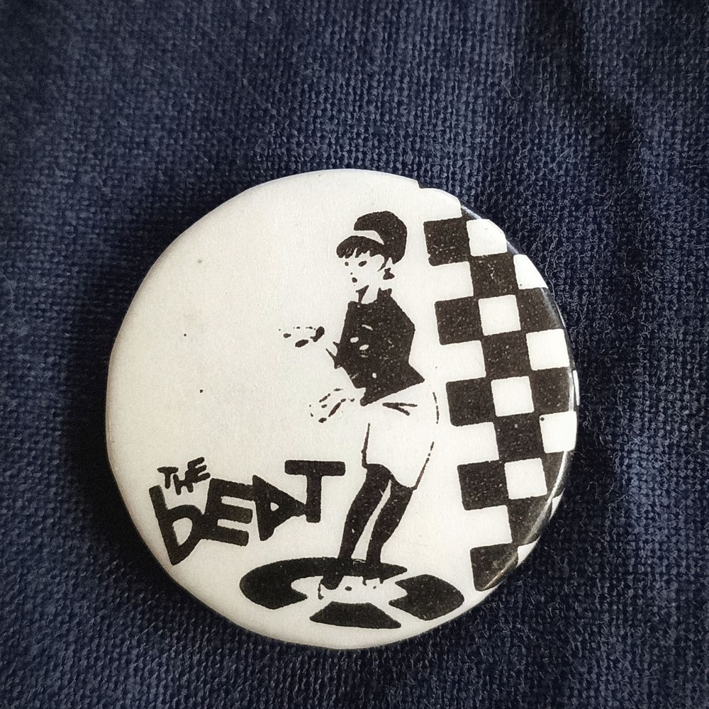 a beat badge featuring an illustration of brigitte bond dancing