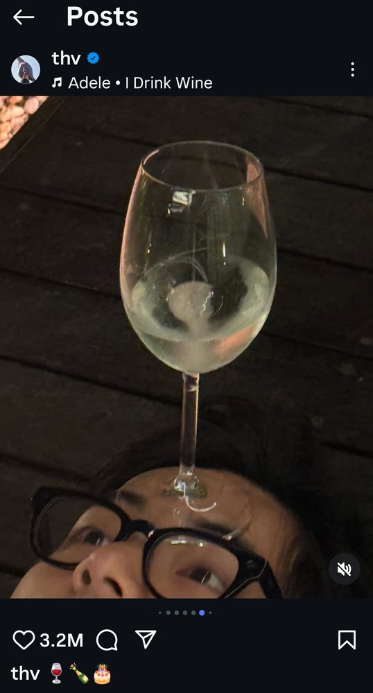 Bts v lying down, balancing a wine glass on his forehead