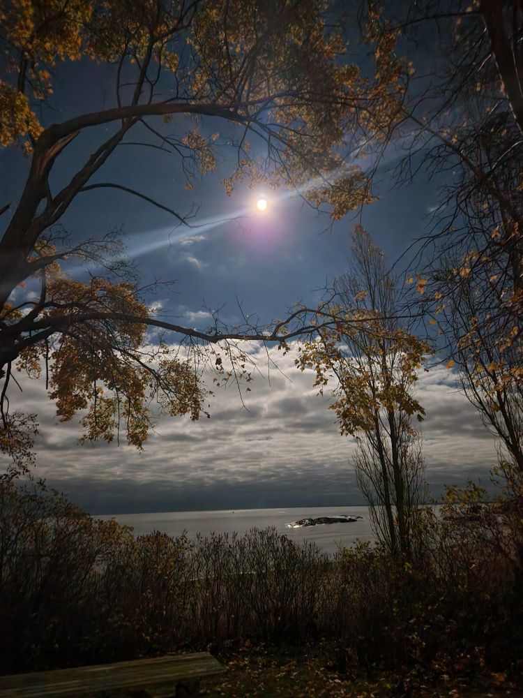 The moon rising over a cove of Lake Superior in Marquette,  Michigan.