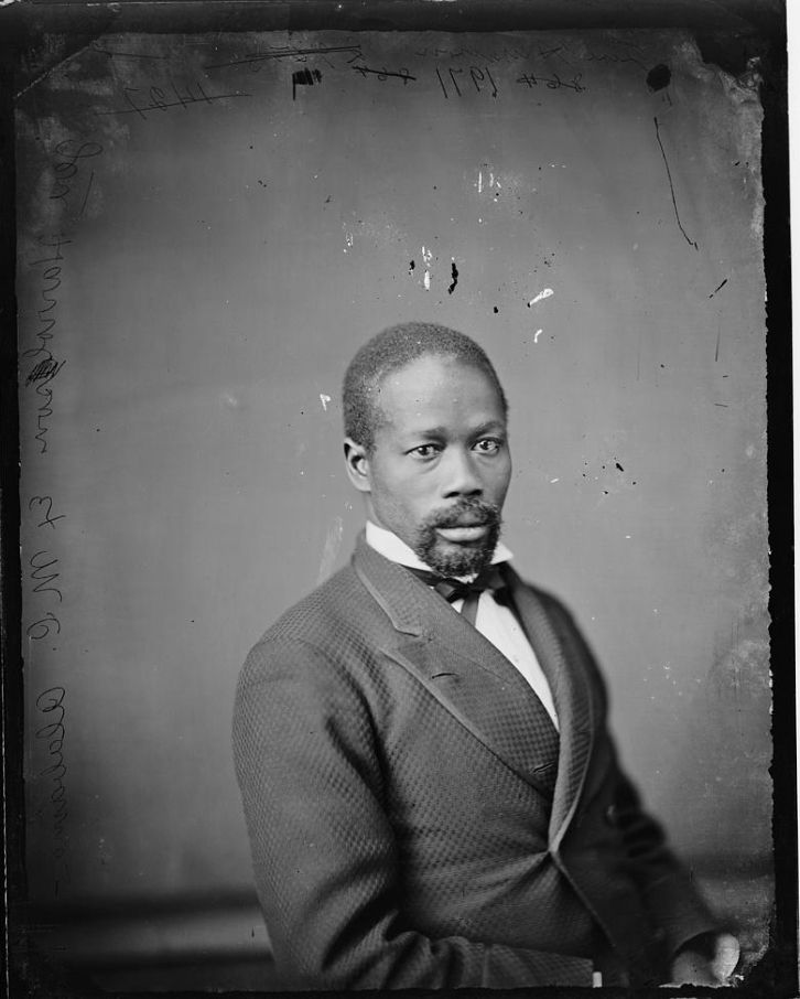 Formal black and white portrait of a man in coat and tie.