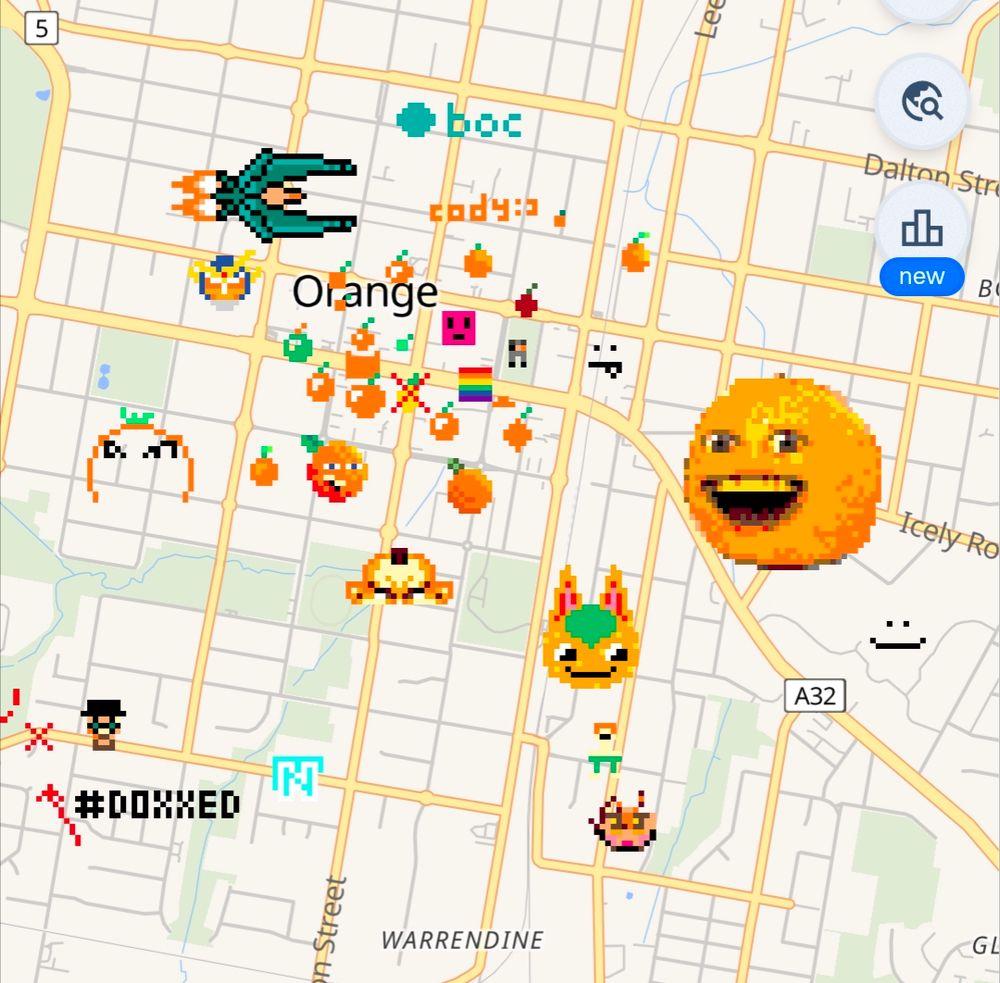 Wplace screenshot showing a bunch of oranges (including the annoying orange) drawn on the town, and an arrow pointing at a random house with the text #doxxed