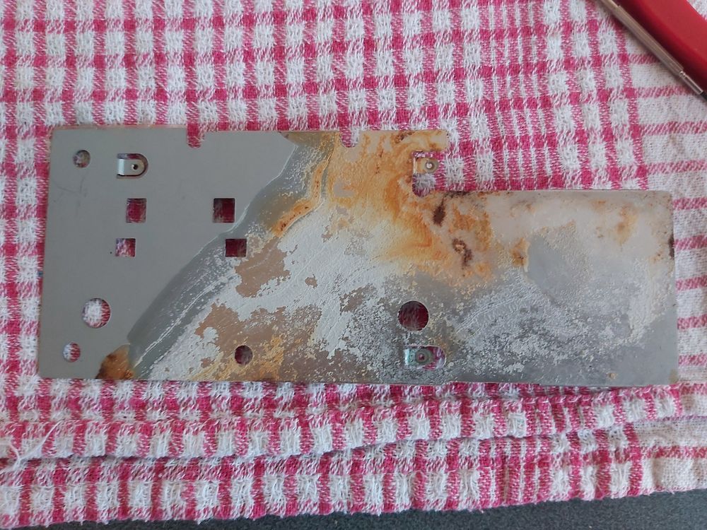 Photo of the back of the metal shield, showing the corroded spots.