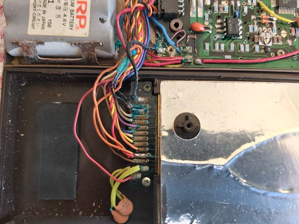 Photo of the inside of the printer showing more corrosion damage caused by the leak.