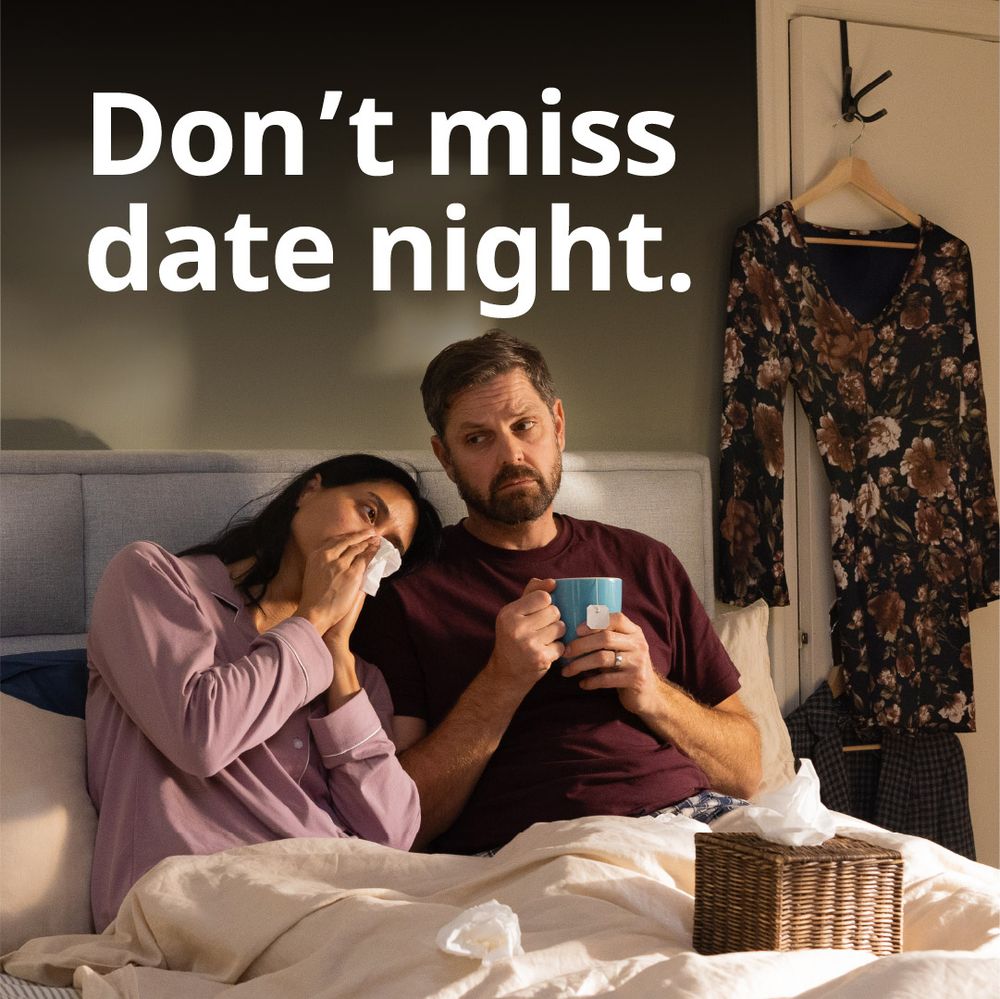 An image of a young couple sick in bed, a woman blowing her nose and a man looking unwell holding a cup of tea, alongside text that says, "Don't miss date night."