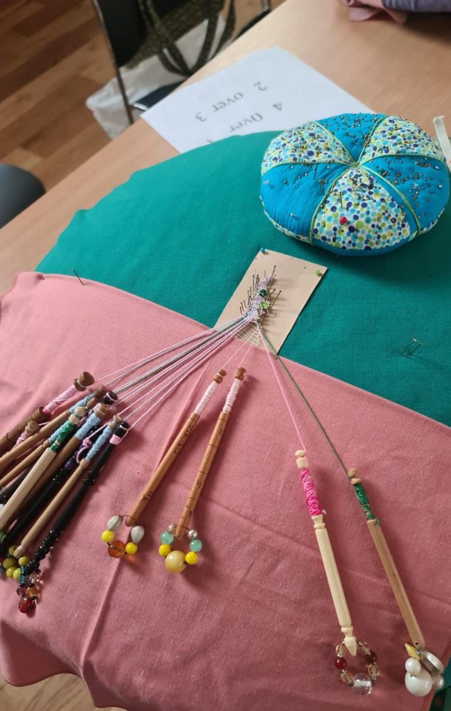 Lace making cushion and bobbins. 