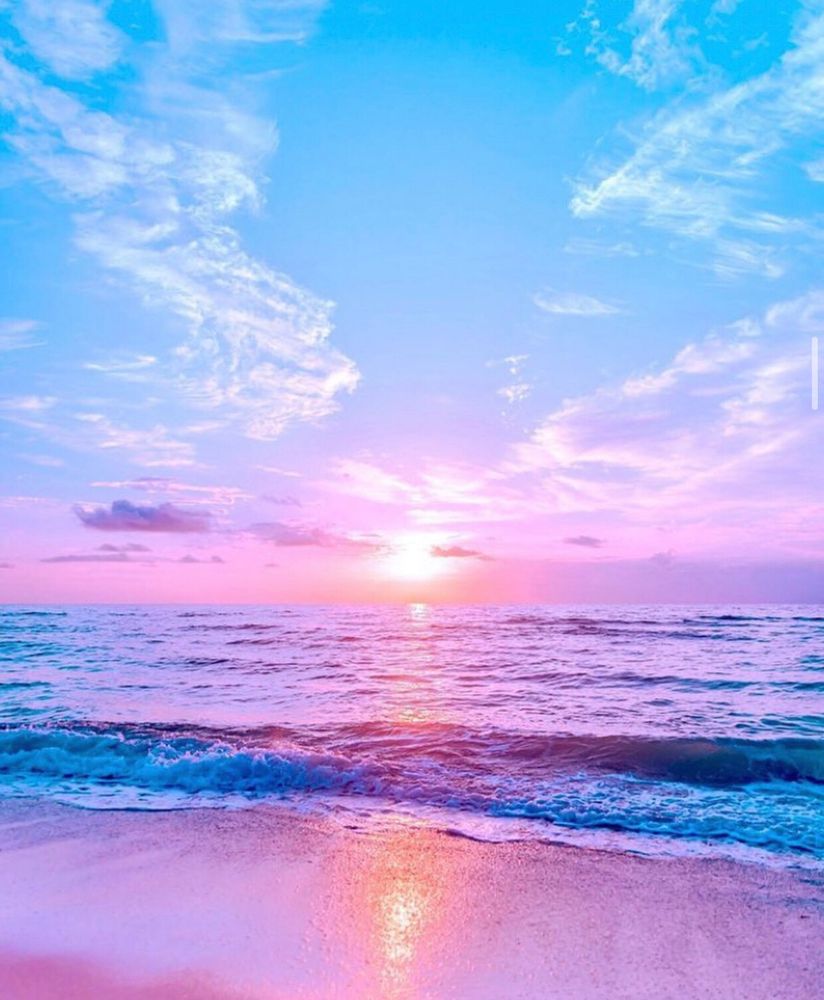 Sunset at the beach. Photograph of the beach, ocean, and sky at sunset in bright purple and pink hues. 