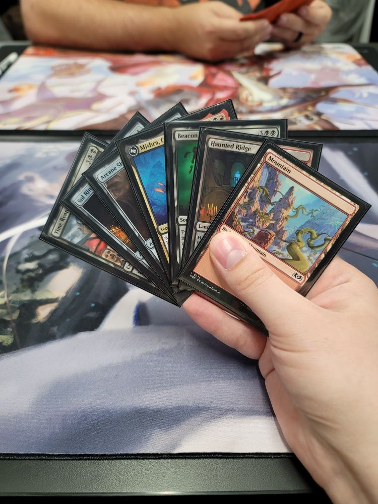 Opening hand including Mountain, Sol Ring, and Arcane Signet for four mana turn 1.