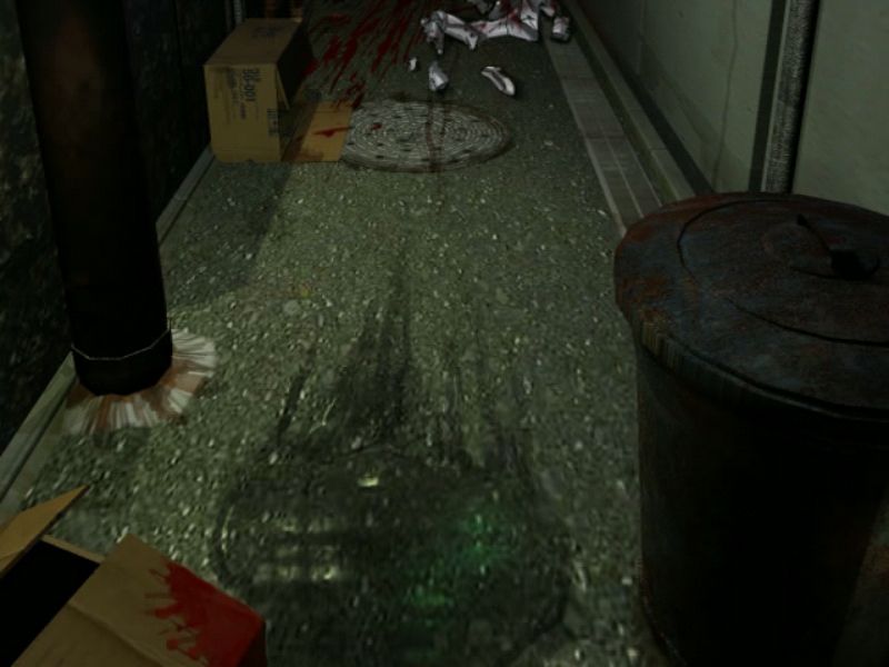 A screenshot from Kuon no Kizuna (Dreamcast). A dirty back alley is shown from a first-person perspective at night. There is a splash of blood on a cardboard box near the front, with a disturbing smear on the floor further away, as if a body has been dragged into a dark corner.