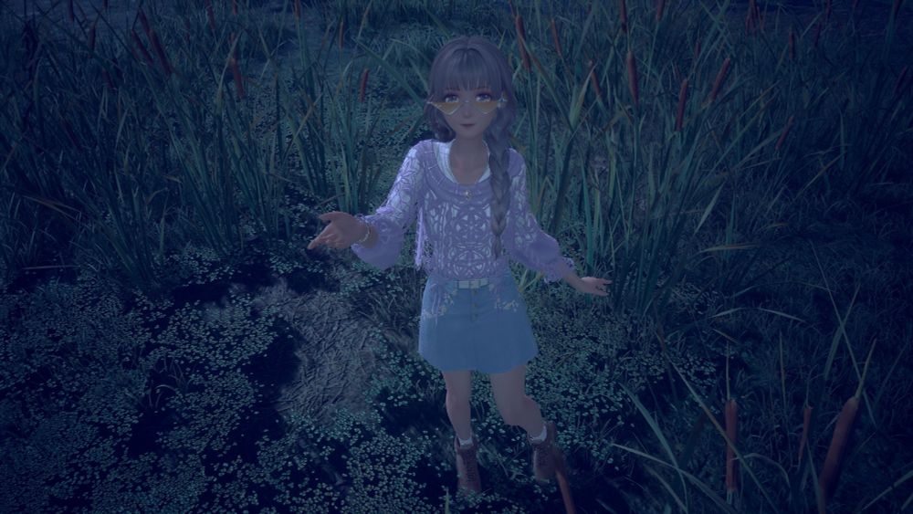 Nikki/Adrianne gestures towards the camera as she stands in the midst of reeds and shallow water at night.