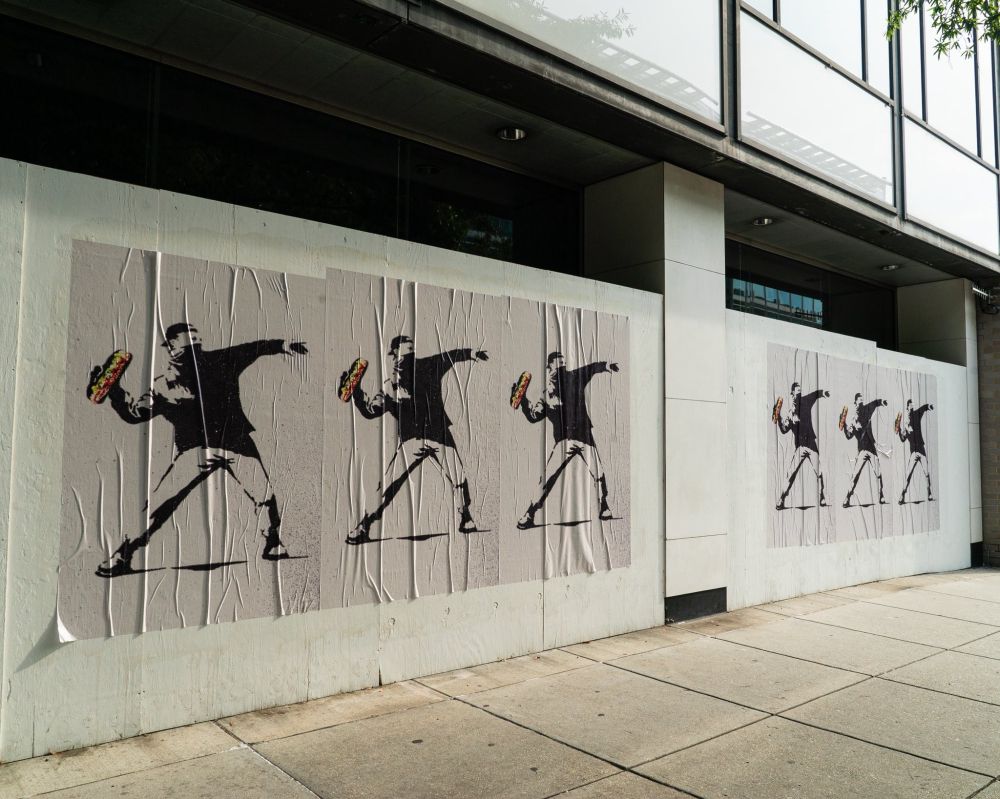 Posters of a man throwing a sandwich