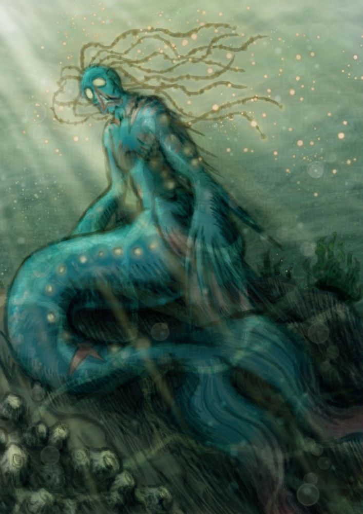 A mermaid sitting on the sea floor.