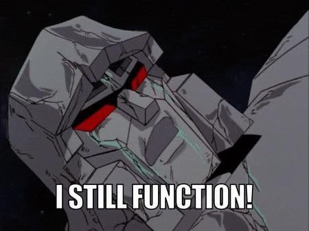 G1 Megatron, badly damaged. Caption says "I STILL FUNCTION."