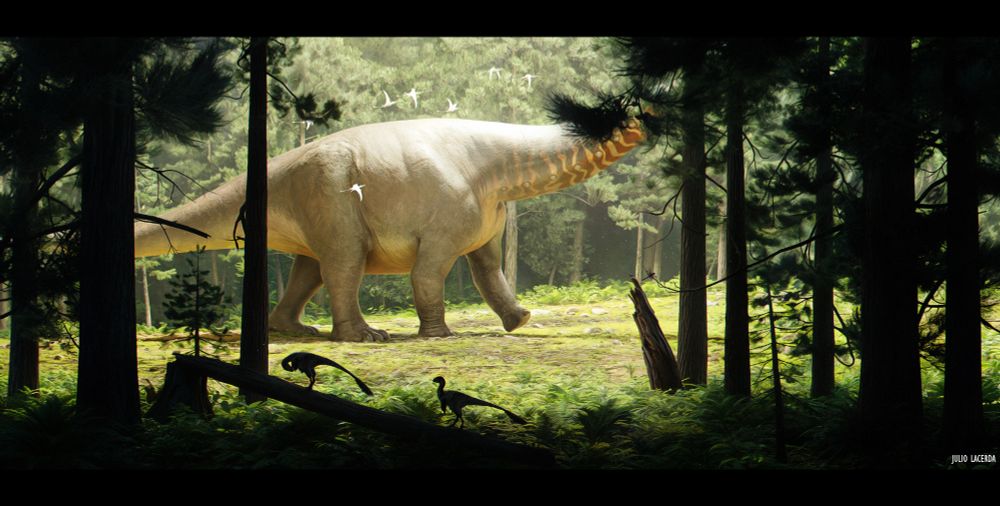 A scar-covered Apatosaurus bull marches through a sunlit clearing, its head and lower tail obscured by the dark forest vegetation that frames the scene. A pair of Ornitholestes climb onto a fallen log in the background. White Pterosaurs fly alongside the sauropod.