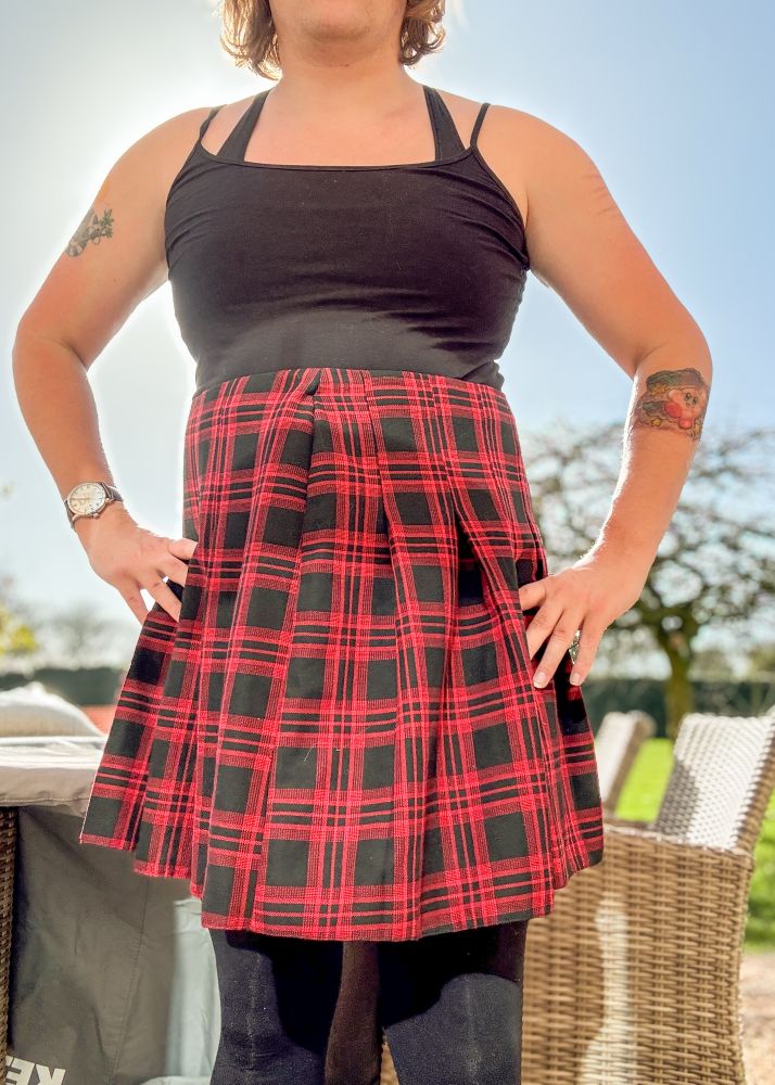 Girl in red and black skirt, black top and black tights 