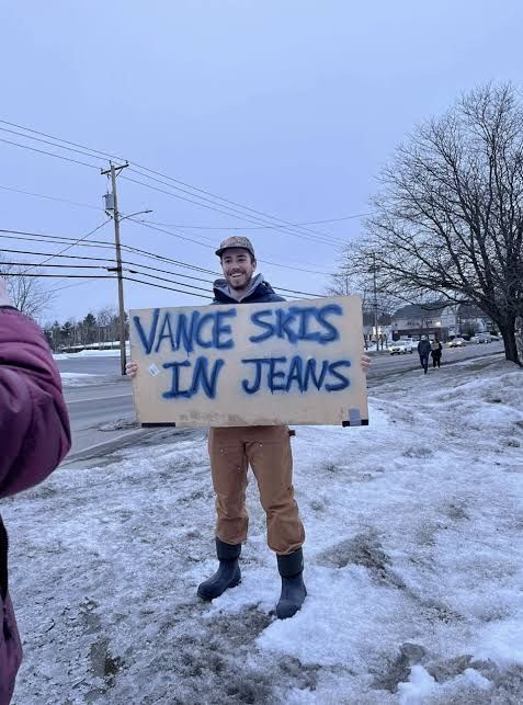 A third Vermont protestor holding a third "VANCE SKIS IN JEANS" sign