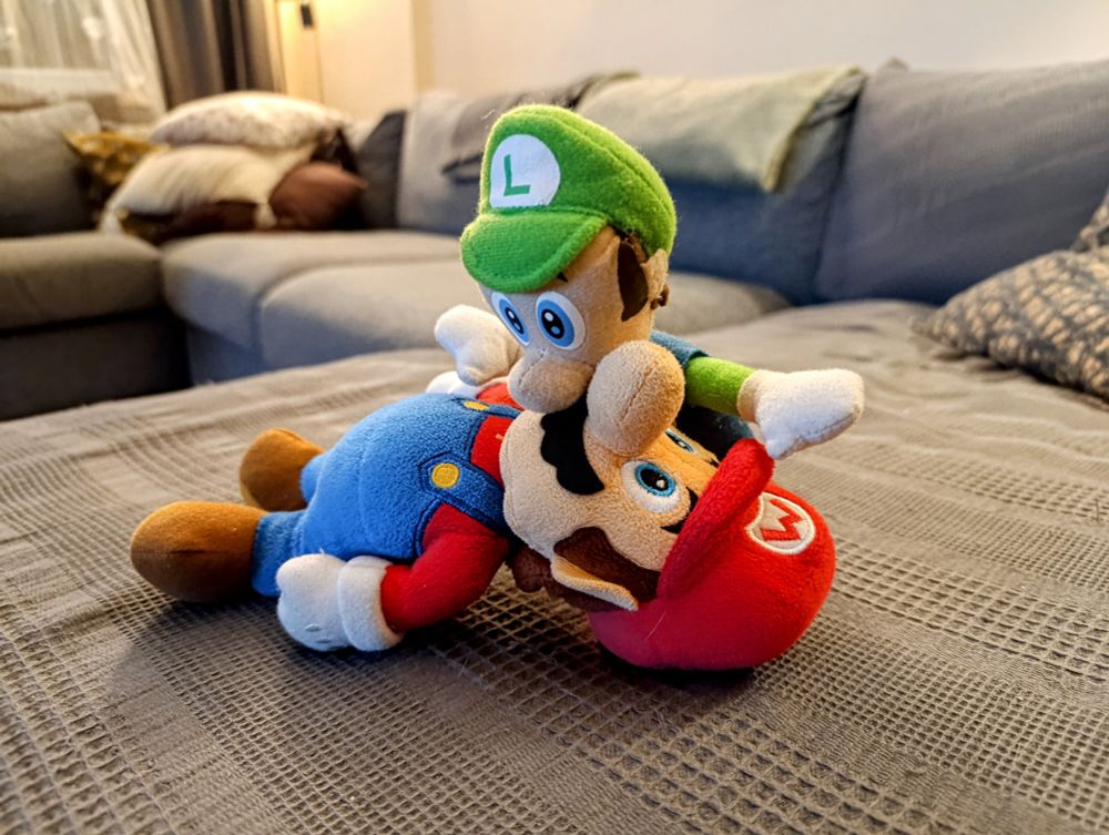 Plush Mario and Luigi (no, not that one) making out on my sofa, the filthy animals