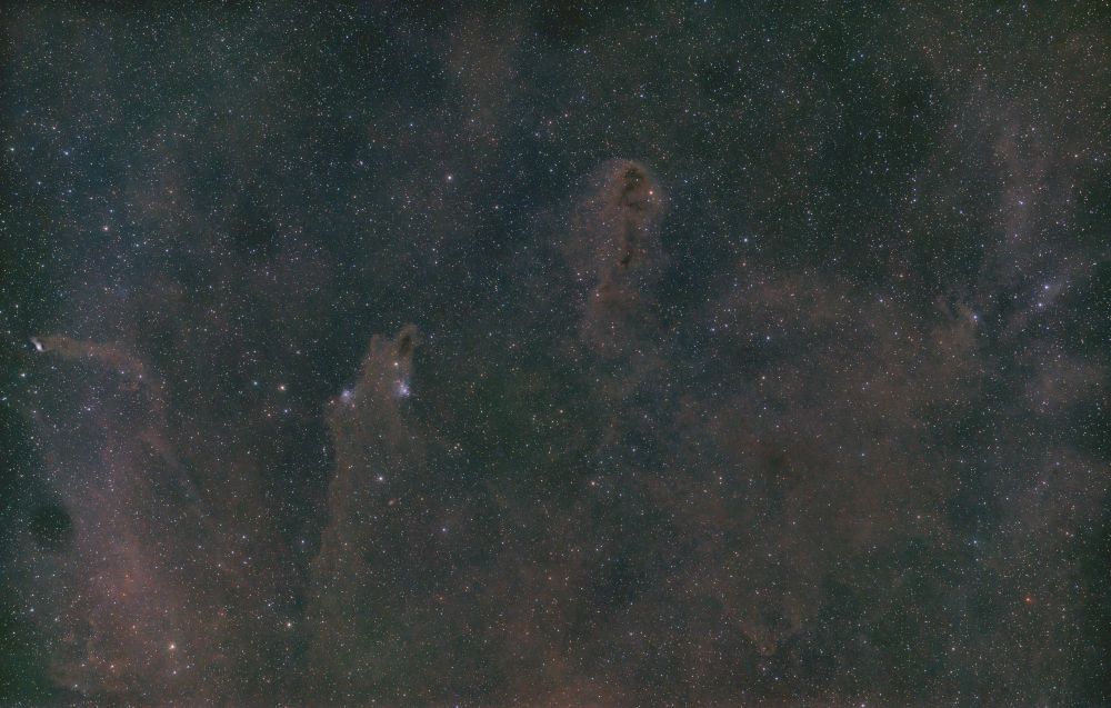 The image is of dark galactic structures throughout the whole frame. Slightly to the left is the Dark Shark Nebula, resembling a shark in the form of dark galactic dust. Multiple other dark structures can be seen throughout. 