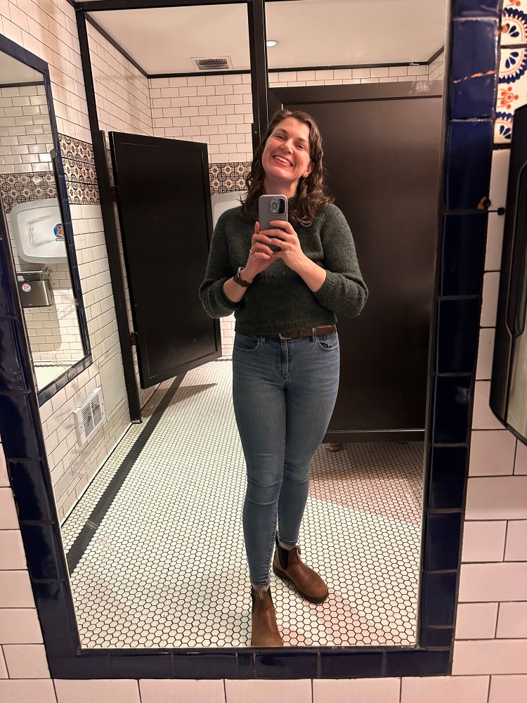 I’m taking a selfie in a restaurant’s bathroom, proudly wearing the green sweater I just knitted