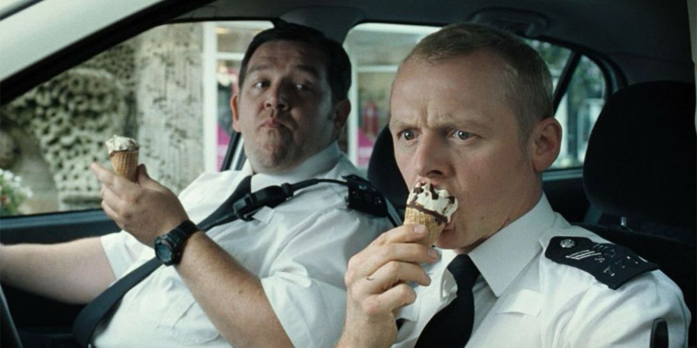 Nicholas Angel (Simon Pegg) and Danny Butterman (Nick Frost) in Hot Fuzz. They both are inside a police car eating cornetto ice cream. 