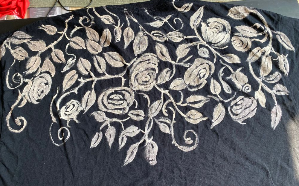 Back view of a hand-painted cheerful Green Man tshirt, size 3XL, a cape of leaves, thorny vines and roses draped over the shoulders.