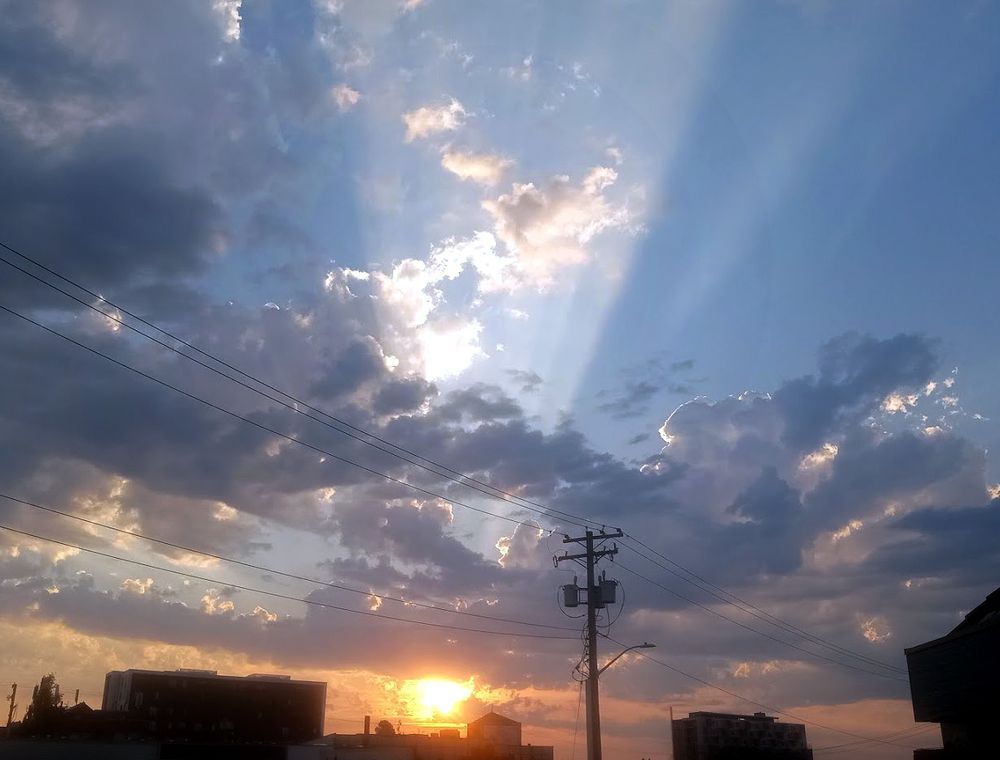 Sunset over midtown Victoria BC... Shafts of light breaking through a cloudy sky. 