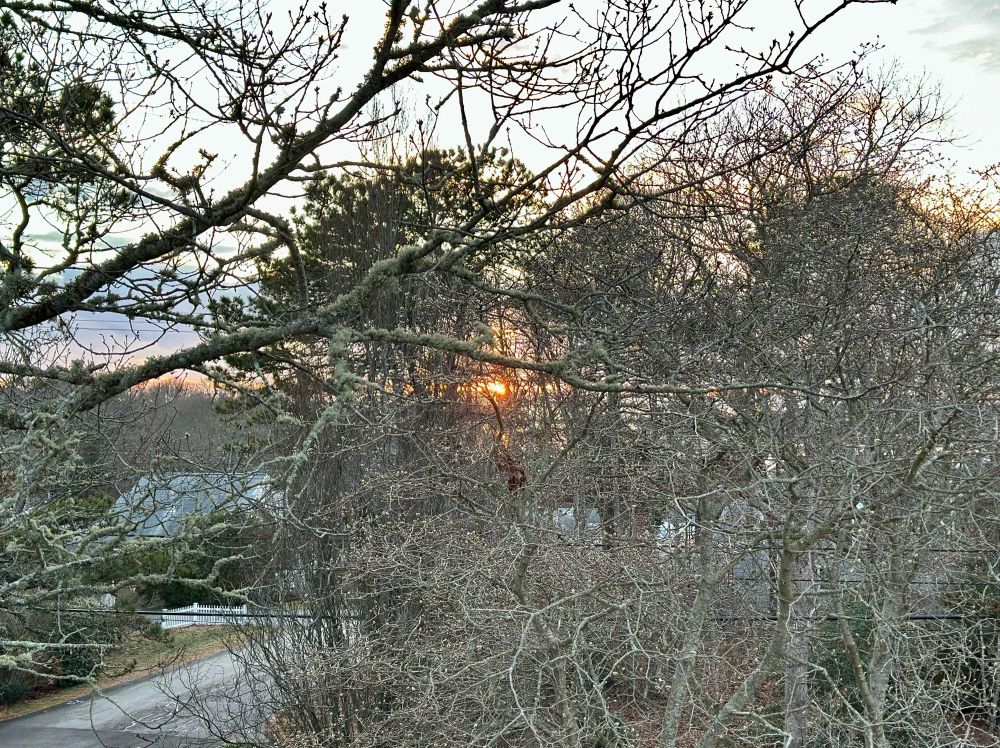 Sun sets on the southwest horizon over Hospital Cove in Cataumet. Buzzards Bay is in the horizon.