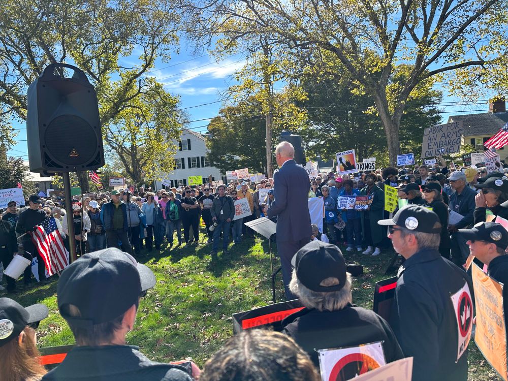 A circle of peaceful protestors gather at the Falmouth Village Green in MA. Rep Keating is speaking.