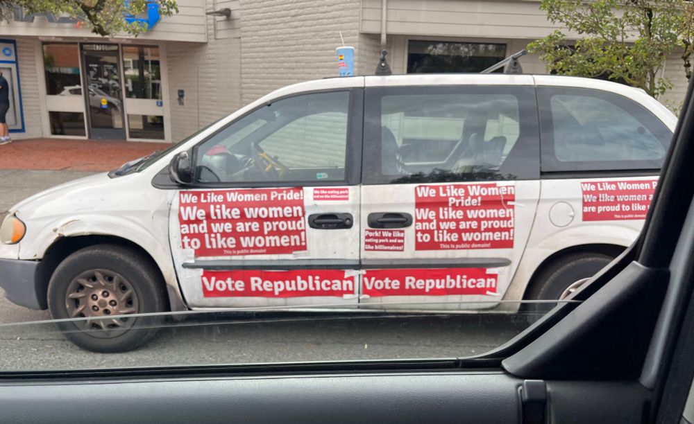a minivan covered in red stickers with white text reading “we like women pride we like women and are proud to like women!” and “vote republican”