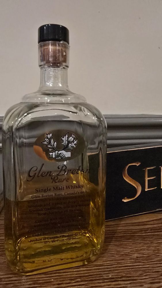 Bottle of Glen Breton rare single malt whiskey next to my "Senators Fan Lives Here" sign. 