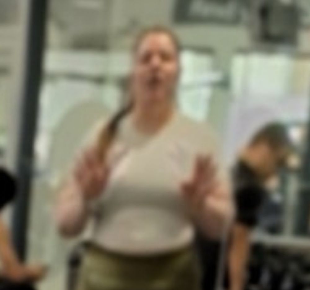 A woman in the background of the above photo who appears to be staring in awe at the beautiful subject, mouth agape. 