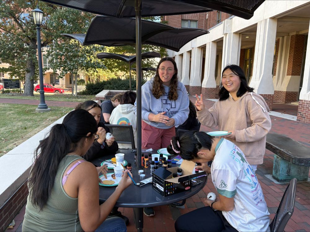 Trainees sitting at tables for the pumpkin painting break from lab work