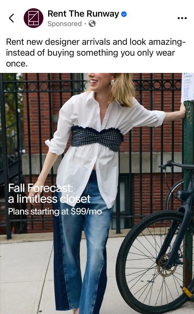 A rent the runway ad showing a smiling woman on a sidewalk, wearing a white button-down shirt with jean; for some unknown reason, the outfit includes some sort of plaid black-and-gray bralet over the shirt