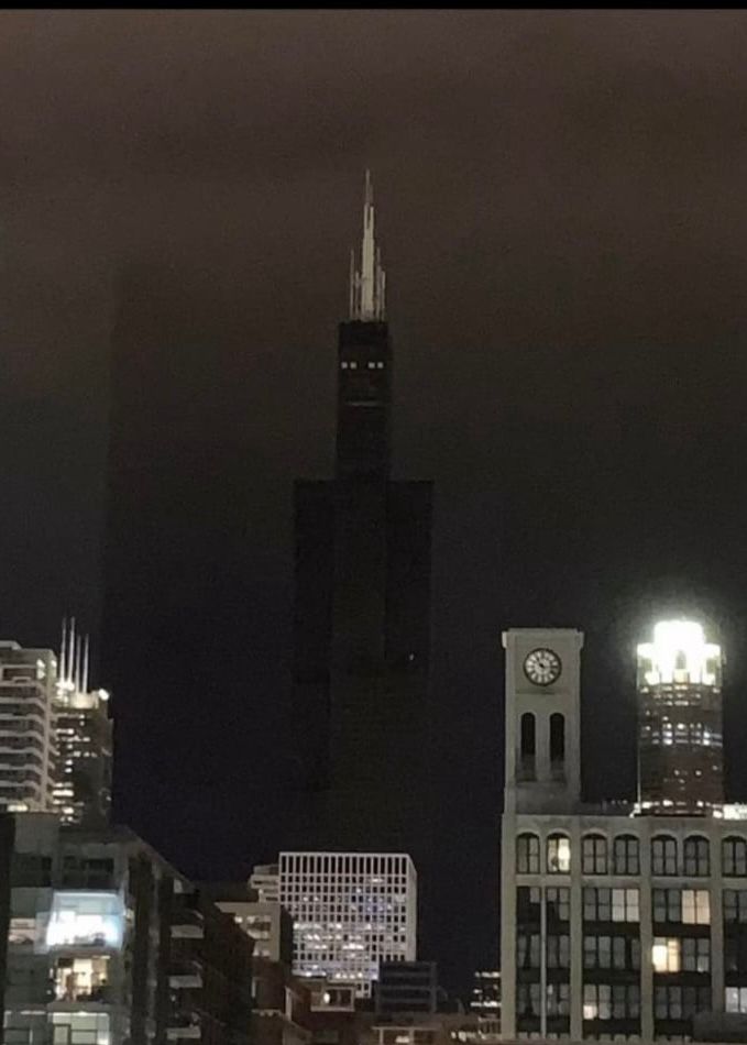 The Sears Tower looking insanely creepy during a blackout, including the impression of a scary face topped by a crown of spikes. It looks like a giant humanoid evil robot or a demonic Minecraft creature. 