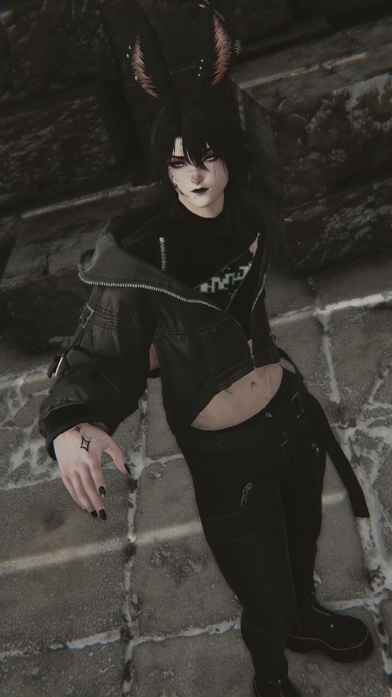 A male viera with black hair, wearing a cropped jacket with black jeans and boots.