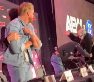 tony khan holding onto orange cassidy whilst watching darby allin trying to murder jon moxley