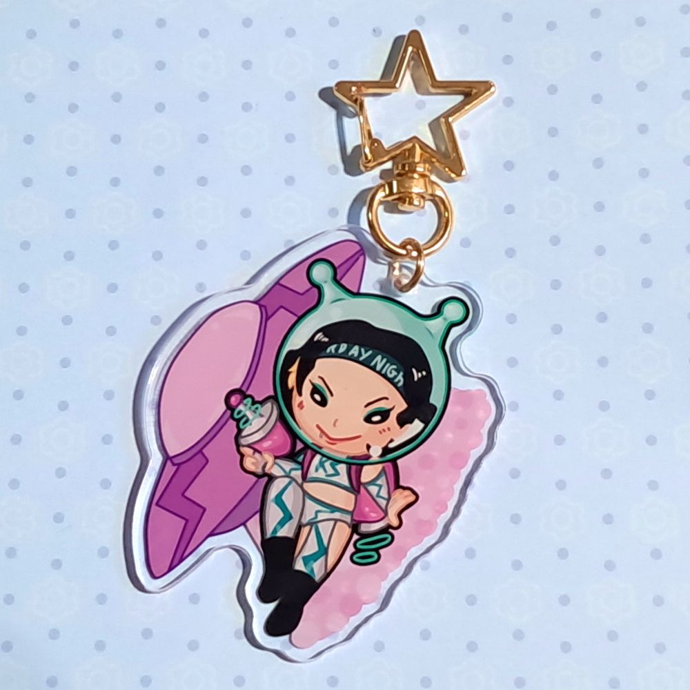 chibi style acrylic keychain/charm of pro wrestler kris statlander on a blue background