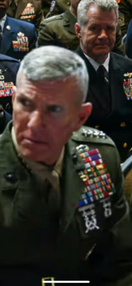 Stoney faced generals with impeccable appearance listen to an alcoholic podcast host tell them what warriors are