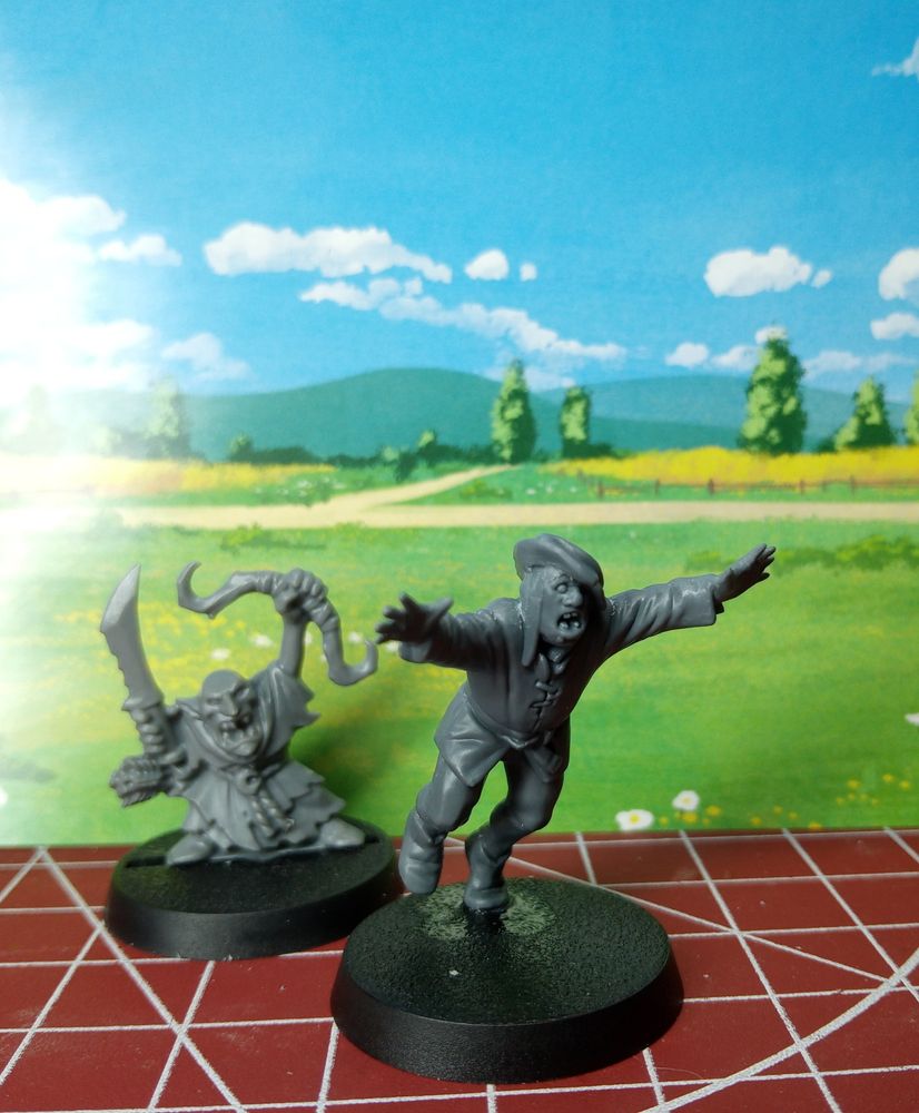 Two plastic miniatures. A goblin brandishing a sword & bow and a man running away screaming.