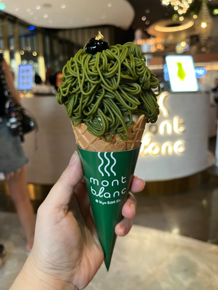 A cone of Mont Blanc matcha chestnut ice cream. It looks like extruded green noodles.
