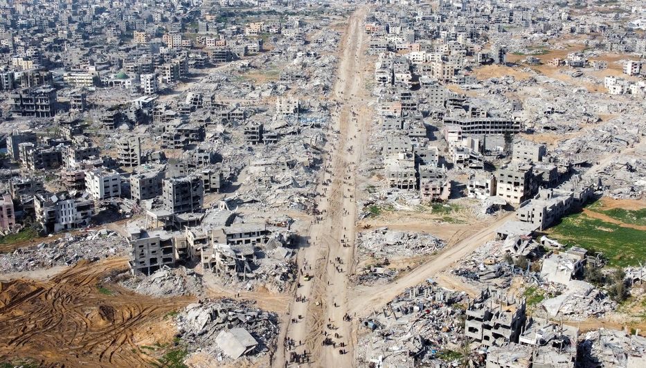 A picture of what Gaza looks like after 15 months of Israel dropping bombs on them. A few buildings standing amongst much concrete rubble and the roads are now dirt. 