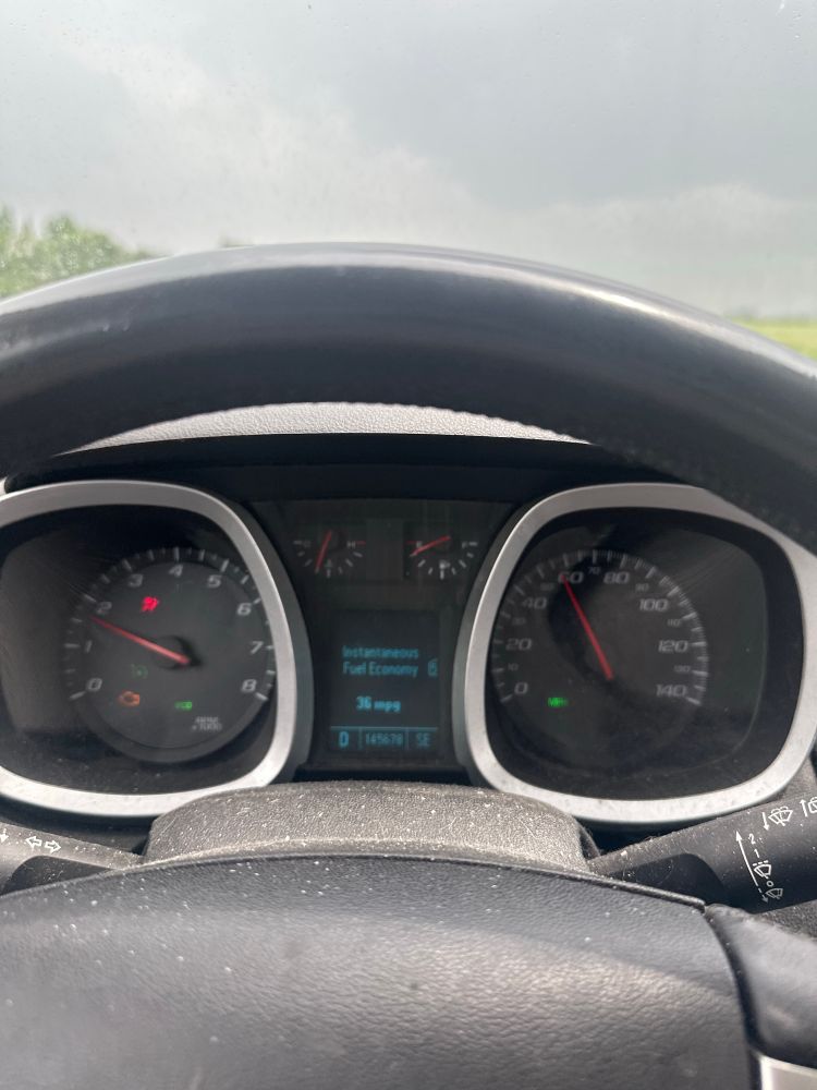Speedometer reading 55 miles an hour on cruise control to save gas even in a 60 mile an hour zone. Check engine light on it’s also raining.