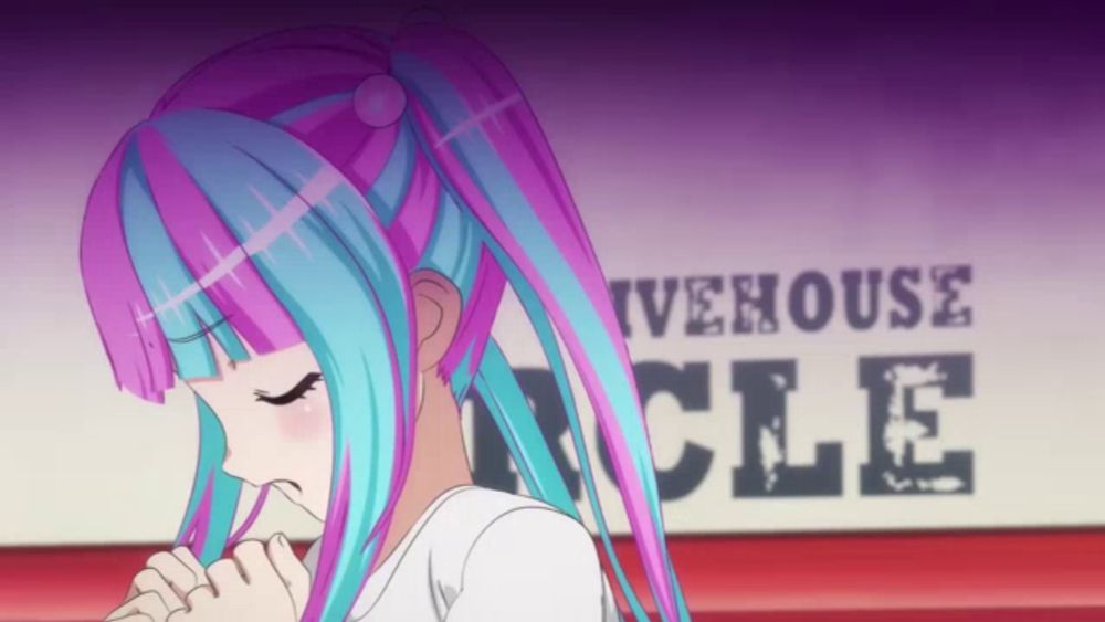 a girl with blue and pink hair is standing in front of a sign that says ivehouse cle