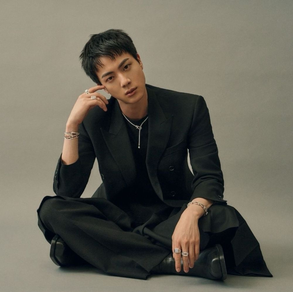 BTS Jin wearing a dark suit and jewelry from Fred as their new global ambassador