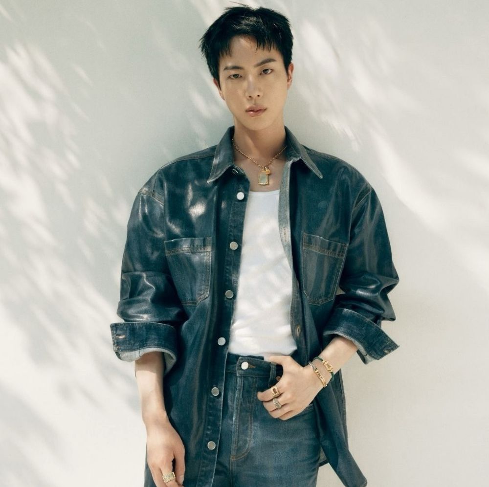 BTS Jin wearing jeans, a denim jacket and white t-shirt with jewelry from Fred as the brand’s new global ambassador