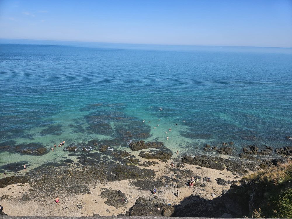 A clear sea with a rocky beach