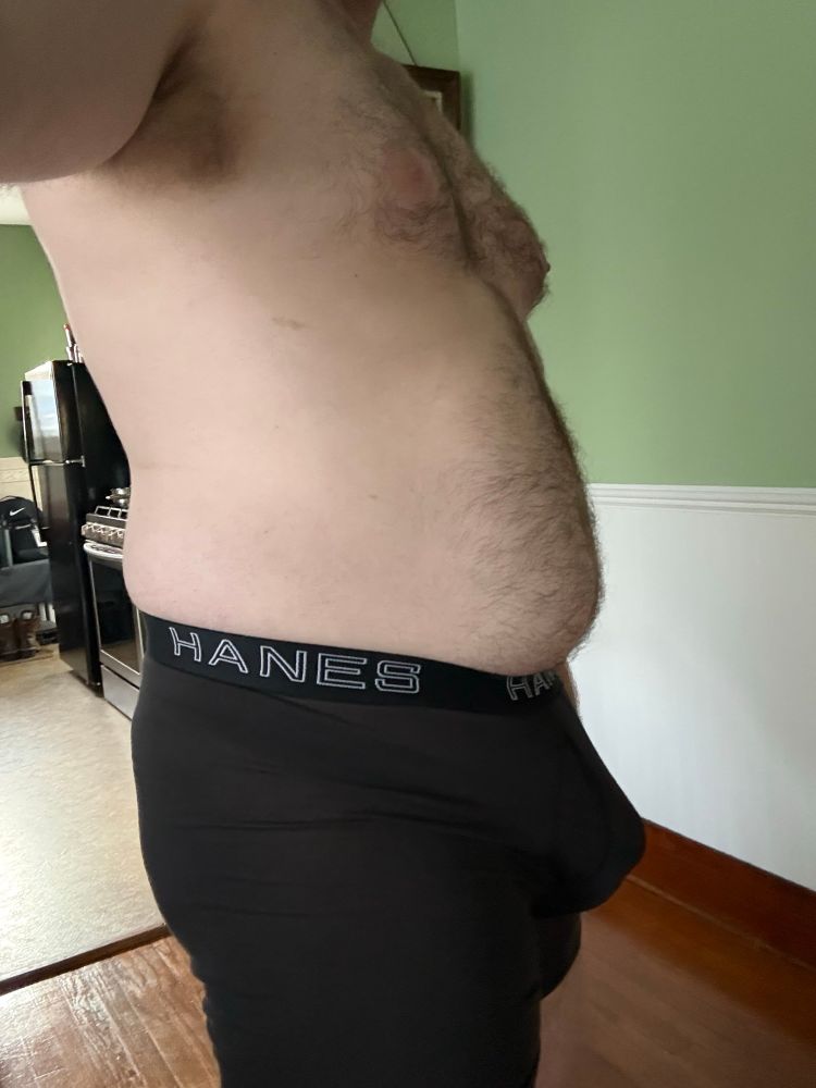 Man bulging in his boxer briefs with the help of a strap + cock ring. 