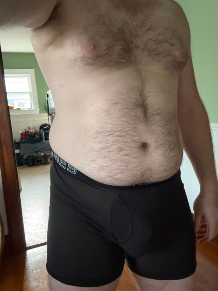 Man bulging in his boxer briefs with the help of a strap + cock ring. 