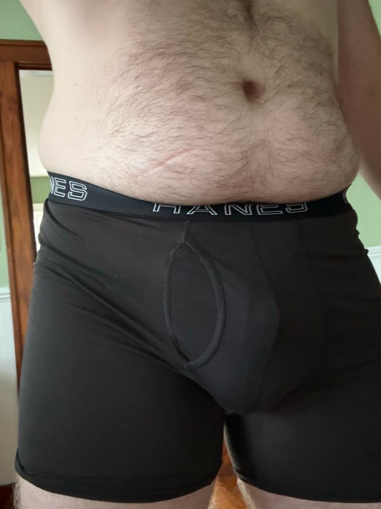 Man bulging in his boxer briefs with the help of a strap + cock ring. 