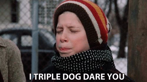 a boy wearing a striped hat and scarf says " i triple dog dare you "